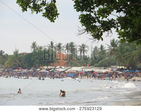 Anyer, Indonesia - June 24, 2018: Crowd Of People Doing Activities At Sambolo Beach. Month Of June I