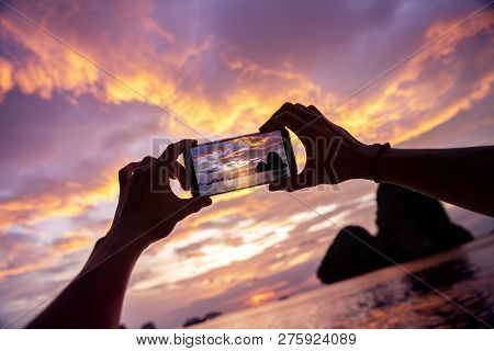 Closeup Photo Of Hands Taking A Photo From Mobile Phone. Krabi Province, Railay Beach On Background