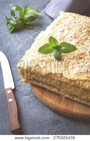 Layered Cake With Cream Napoleon Millefeuille Vanilla Slice With Mint On Dark Background.