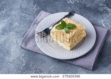 Layered Cake With Cream Napoleon Millefeuille Vanilla Slice With Mint On Dark Background.