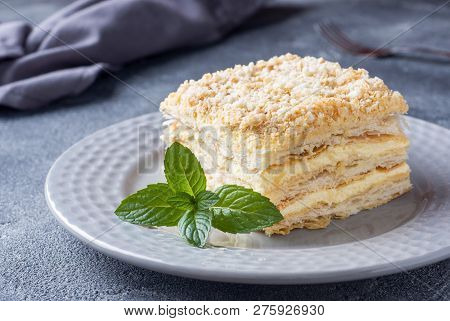 Layered Cake With Cream Napoleon Millefeuille Vanilla Slice With Mint On Dark Background.