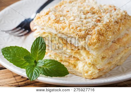 Layered Cake With Cream Napoleon Millefeuille Vanilla Slice With Mint On Wooden Background.