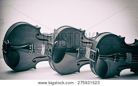The Abstrat Artdesign Background Of Three Violins Put On Background,show Detail Of Half Front Side,