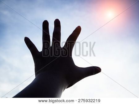 The Silhouette Humand Hand Reaching To The Sky