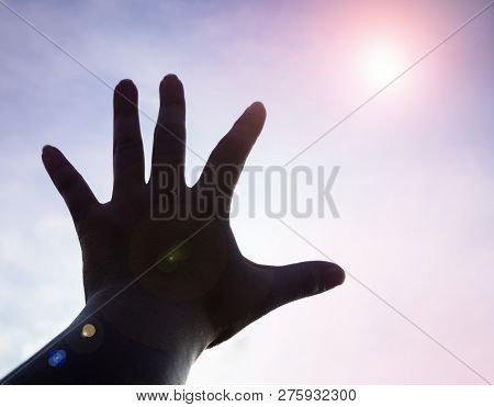 The Silhouette Humand Hand Reaching To The Sky