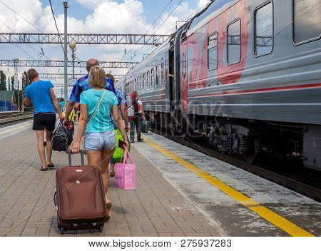 Voronezh, Russia - August 05, 2018: Passengers Go Along The Platform To Their Wagon