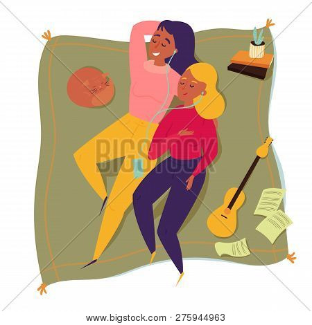 Top View Of Two Woman Friends On A Picnic Blanket. Couple Of Friends Are Listening To Music. Home Va