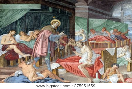 LUGANO, SWITZERLAND - JUNE 24, 2018: Scene of Saint Roch's life, by Marco Antonio Pozzi, fresco in the Saint Roch church in Lugano, Switzerland