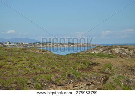 Beautiful Green And Purple Field With The Horizon And Cantabrian Sea In The Background On The Beach 