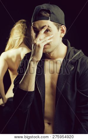 Guy And Naked Sexy Girl Showing Graceful Back, Man In Black Cap And Shirt Has Bare Torso Holds Hand 