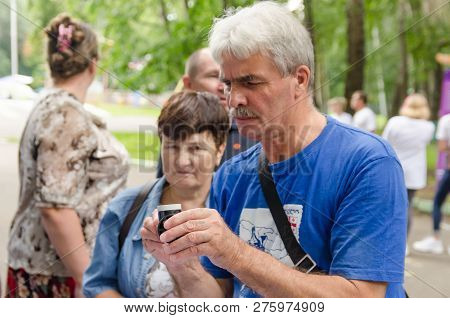 Komsomolsk-on-amur, Russia - August 19, 2018. Elderly Man Takes Device To Measure Volume Of The Lung