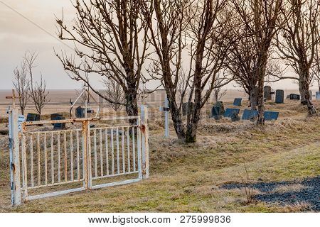 Gate Into The Kalfafellsstadur Church Graveyard In Iceland With Crosses, Headstones And Long Grass C
