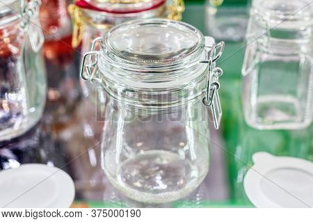 Glass Jars With Glass Lockable Lids. Stand On A Shelf A Shop Window.