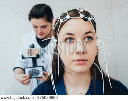 Doctor And Patient With Encephalography Electrode. Electroencephalogram