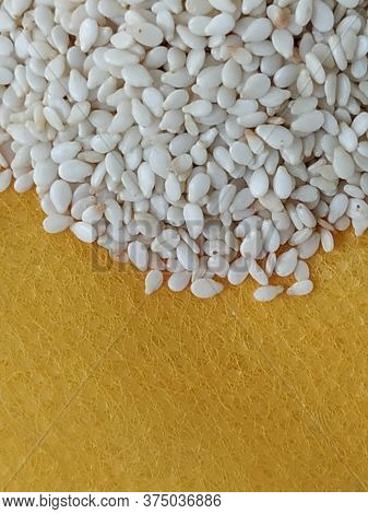 Pile And Heap Of A White Sesame Or Gingili Seeds. Texture And Backdrop