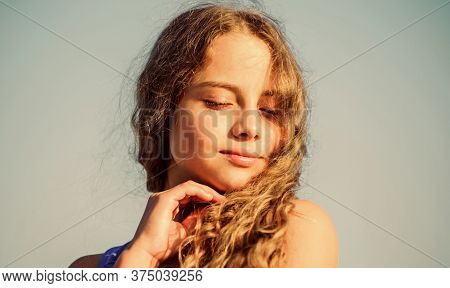 Feeling Playful. Kid Fashion. Pretty Child Outdoor. Natural Beauty. Small Girl Long Culry Hair. Happ