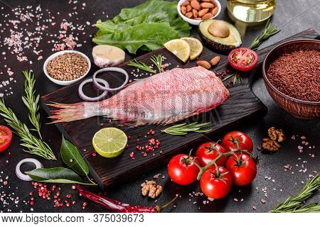 Raw Fillet Of Red Sea Perch Prepared For Baking With Spices And Herbs