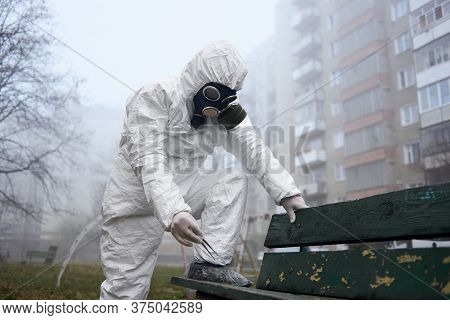 Research Scientist Holding Tweezers While Standing By Bench. Male Environmentalist Wearing Protectiv