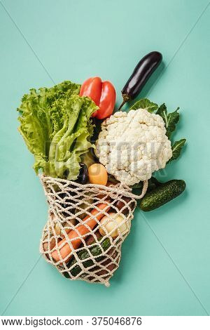 Various Fresh Vegetables In Eco-friendly Bag On Turquoise Background. Vegetarian Meal From The Marke