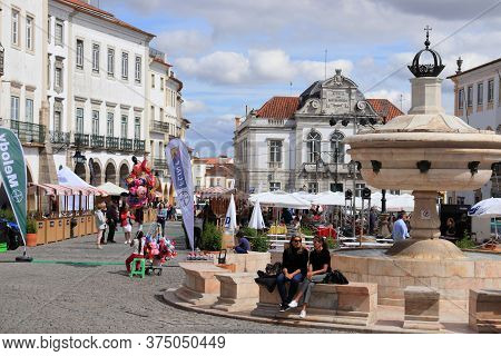Evora, Portugal - June 3, 2018: People Visit Giraldo Square (praca Do Giraldo) In Evora, Portugal. E