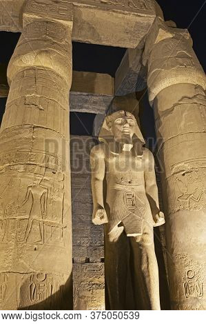 Large Statue Of Ramses Ii With Columns In Hypostyle Hall At Ancient Egyptian Luxor Temple Lit Up Dur
