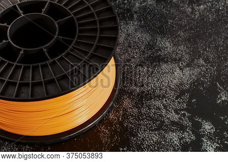 Filament For 3d Printing. Bright Thermoplastic Of Neon Orange, Color. Reel Horizontal View. Macro