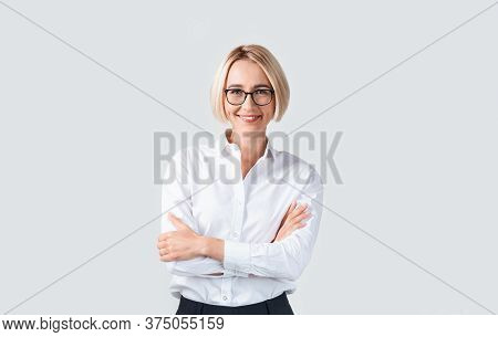 Proffessional Secretary In Formal Wear With Crossed Arms Against Light Background