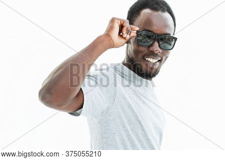 Handsome Guy Looking Intently Through Sunglasses . Isolated On White