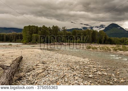 Braided Shames River As It Flows Into The Skeena River On An Overcast Day, With Woodland And Mountai