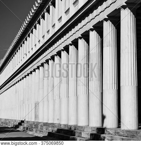 Row of cassical greek columns, Athens, Greece. Black and white architectural photography
