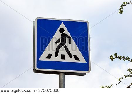 Pedestrian Crossing Sign On Sky Background. Warning Sign. Traffic Laws.