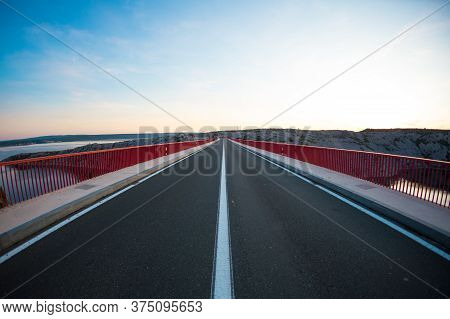 Red Bridge Over The Canyon In Croatia At Sunset. View From The Bridge To The Canyon In The Krka Nati