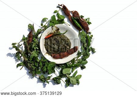 Pudina Chutney Or Field Mint Leaves Paste In A Plate With Raw Ingredients Isolated On White Backgrou