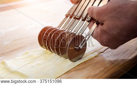 Chef Rolling Dough With A Pasta Machine. Pasta Maker Machine.