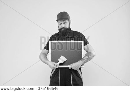 Creative Decorator. Painting Works. Bearded Decorator Hold Chalkboard Advertisement Copy Space. Repa