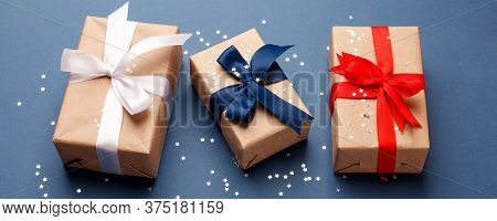 Red, Blue And White Gift Boxes On Classic Blue Background In The National Colors Of America, Russia,