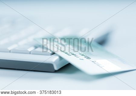 Bank creadit card on keyboard. Concept of online banking and internet purchase. Soft focus.