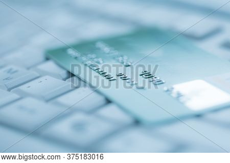 Bank creadit card on keyboard. Concept of online banking and internet purchase. Soft focus.