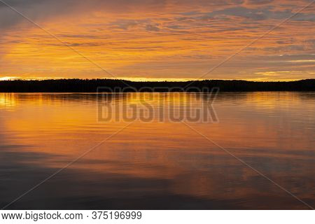 Water Surface. Sunset Sky Background. Gold Sunset Sky With Evening Sky Clouds Over The Lake. Small W