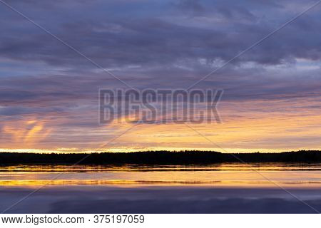 Water Surface. Sunset Sky Background. Gold Sunset Sky With Evening Sky Clouds Over The Lake. Small W