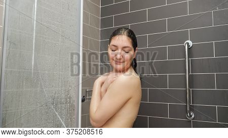 Pretty Girl W Stands Under Shower And Enjoying In Tiled Bathroom At Home Closeup
