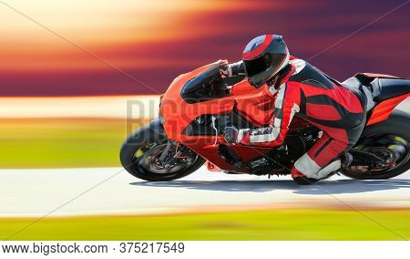 Motorcycle Leaning Into A Fast Corner On Race Track