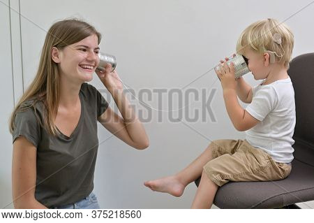 A Boy With Cochlear Implants Playing Tin Can Phone