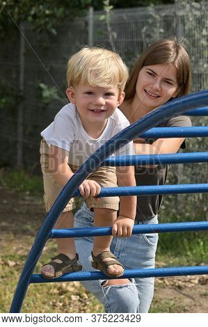 A Boy With Cochlear Implants Playing In Summer Park