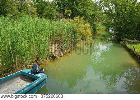 An Old Wooden Fishing Boat In The Wetland Area Of Isola Della Cona In Friuli-venezia Giulia, North E