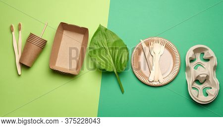 Disposable Paper Utensils From Brown Craft Paper And Recycled Materials On A Green Background, Plast
