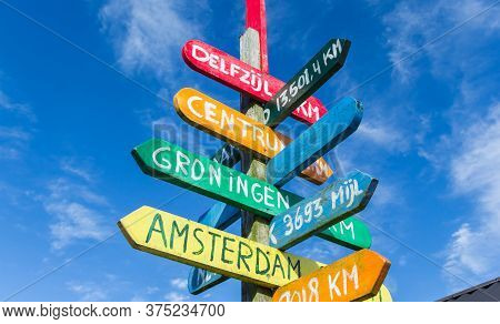 Colorful Signpost Pointing To Various Cities In Appingedam, Netherlands