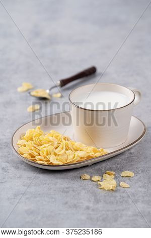 Corn Flakes Bowl Sweeties With Milk On Gray Cement Background, Close Up, Fresh And Healthy Breakbast