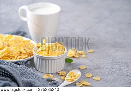 Corn Flakes Bowl Sweeties With Milk On Gray Cement Background, Close Up, Fresh And Healthy Breakbast