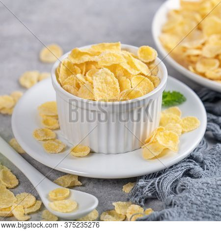 Corn Flakes Bowl Sweeties With Milk On Gray Cement Background, Close Up, Fresh And Healthy Breakbast